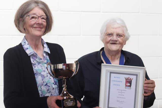 Anne Travers from the Group receiving the McLaren Trophy from Madelene Hunt of Bo'ness Community Council.