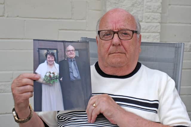 Alec Bowman holds a photograph of himself and wife Euphemia on the day renewed their wedding vows to celebrate their Golden Wedding. Picture: Michael Gillen.