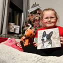 Ellie Forsyth, 6, who has been raising money for presents for Dogs Trust in memory of her own pooch Eva, pictured (Picture: Michael Gillen, National World)