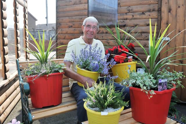 Alisdair Brown with his flowers which he sells to raise funds for Strathcarron Hospice at AMR Log Cabins, in Grahams Road, Falkirk