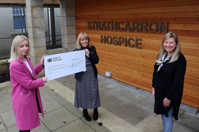 Drummond Laurie Chartered Accountants, of Grangemouth, hand over a cheque for £6078 raised via a virtual 10k to Strathcarron Hospice. Julie McVicar, associate director of Drummond Laurie, and and Gillian Niven, client care and development manager, present the cheque to Marion Blaney, Strathcarron community fundraiser. Picture: Michael Gillen.