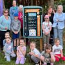 Children and staff from Kidz Stop next to one of the newly installed litter picking boards.