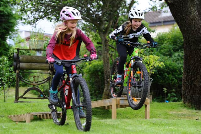 Laurieston girls Scarlett and Sophie Mitchell will cycle 35 miles from The Falkirk Wheel to Edinburgh for Prostate Cancer UK, accompanied by their mum Joanne and dad Alistair. Picture: Michael Gillen.