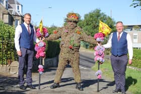 Burryman and his two attendants, Duncan Thompson (L) and Andrew Findlater prepare to leave The Provost's House.