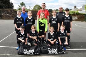 Carmuirs Primay pupils in their strips with Robert Marshall, RJM Sports MD; Calum Brown, teacher and Steven Allison, Camelon Juniors director of football. Pic: Michael Gillen