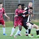 Dunipace forward Sam Colley fends off his Tynecastle opponent (Photo: Michael Gillen)