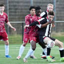 Dunipace forward Sam Colley fends off his Tynecastle opponent (Photo: Michael Gillen)