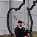 A lone piper plays during the YOI Armistice Day event