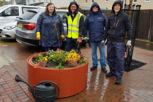 Stock photo of members of Winchburgh Community Growing Group with finished planters.