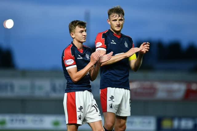 Finn Yeats applauds the Falkirk support alongside Bairns' team-mate Coll Donaldson (Photo: Michael Gillen)