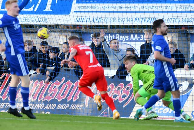 Callumn Morrison wheels away after scoring the opening goal in the first half