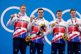 L to R: Britain's Tom Dean, James Guy, Matthew Richards and Duncan Scott pose on the podium after the final of the men's 4x200m freestyle relay swimming event (Pic: Odd Andresen/AFP via Getty Images)