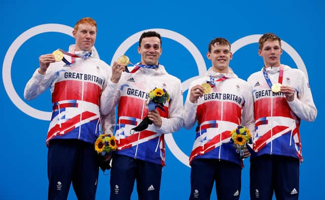 L to R: Britain's Tom Dean, James Guy, Matthew Richards and Duncan Scott pose on the podium after the final of the men's 4x200m freestyle relay swimming event (Pic: Odd Andresen/AFP via Getty Images)