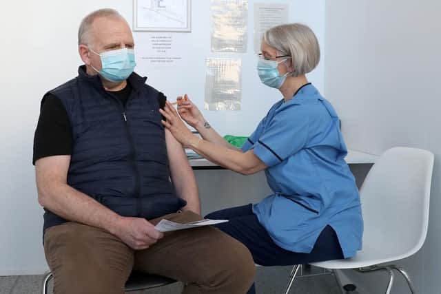 Gillian Bruce, co-ordinator with the immunisation team at NHS Forth Valley, gives a vaccine to Ian Love from Dunipace at Forth Valley College's Stirling campus as the Scottish Government announces it has vaccinated over two million people. Picture: Andrew Milligan/PA Wire.