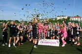 Dunipace players and coaching staff celebrate with the SWFL West trophy after sealing the league title last Sunday with a 6-0 win at Gleniffer Thistle (Pictures by Ian Sneddon)