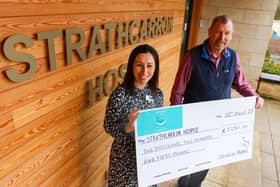 John Black of The Station Hotel hands over a cheque for £2250 to Strathcarron's corporate fundraiser Claire Kennedy.  (Pic: Scott Louden)