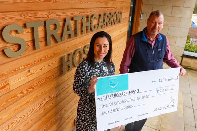 John Black of The Station Hotel hands over a cheque for £2250 to Strathcarron's corporate fundraiser Claire Kennedy.  (Pic: Scott Louden)