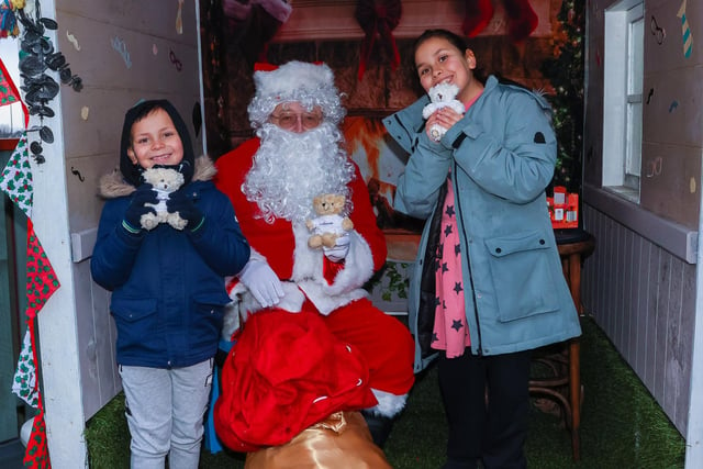 Hamza, 7, and Aisha, 10, from Falkirk pop in to visit Santa
