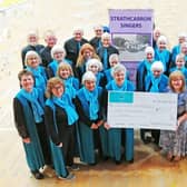 Linda Marshall, secretary of the Strathcarron Singers, hands over a cheque for £5000 to Marjory Mackay, director of nursing at Strathcarron Hospice.  (Pic: submitted)