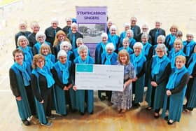 Linda Marshall, secretary of the Strathcarron Singers, hands over a cheque for £5000 to Marjory Mackay, director of nursing at Strathcarron Hospice.  (Pic: submitted)