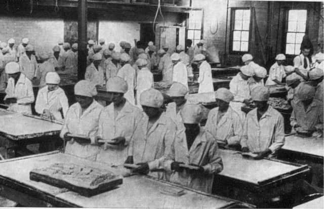 Staff breaking and wrapping tablet in the early days.