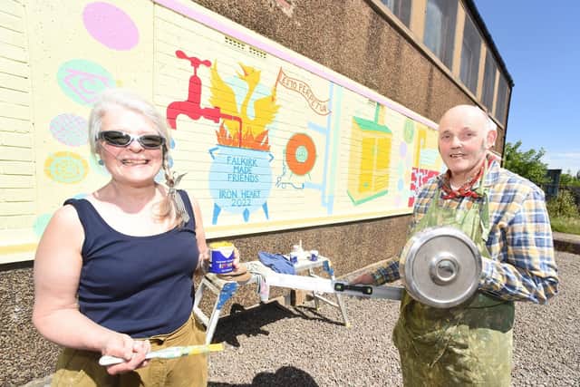 Rowena Comrie and Duncan Comrie with the 'Ironheart 2022' mural. Falkirk Made Friends coined the name Ironheart as a way of uniting the iron achievements of the many iron townships of the Falkirk area.  Pic: Lisa Evans.