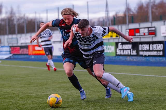 Dean Watson drives forward with the ball