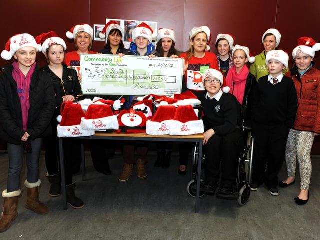 Windsor Park Unit  in Falkirk High School sell 'Asda Text Santa hats', S1 pupils at the school also helped the Windsor Park Unit pupils, 2012.