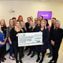 Stephanie Maxwell and the RSM team hand over the cheque for £27,000 to Samantha Merrilees, Scott Martin's mother