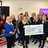 Stephanie Maxwell and the RSM team hand over the cheque for £27,000 to Samantha Merrilees, Scott Martin's mother