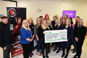 Stephanie Maxwell and the RSM team hand over the cheque for £27,000 to Samantha Merrilees, Scott Martin's mother