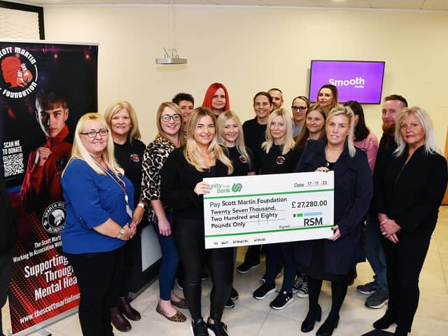 Stephanie Maxwell and the RSM team hand over the cheque for £27,000 to Samantha Merrilees, Scott Martin's mother