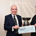 David Wheeler, president of the Rotary Club of Falkirk, left, presents Murray Leslie, store manager Tesco Redding Road, with his trophy and cheque. Pic: Michael Gillen