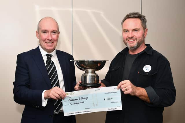 David Wheeler, president of the Rotary Club of Falkirk, left, presents Murray Leslie, store manager Tesco Redding Road, with his trophy and cheque. Pic: Michael Gillen