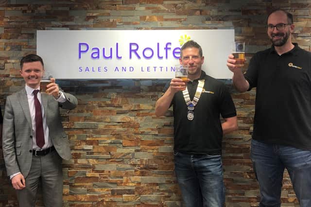 Linlithgow Round Table members toast the beer festival with event sponsor Paul Rolfe Estate Agents' Fraser Neary.