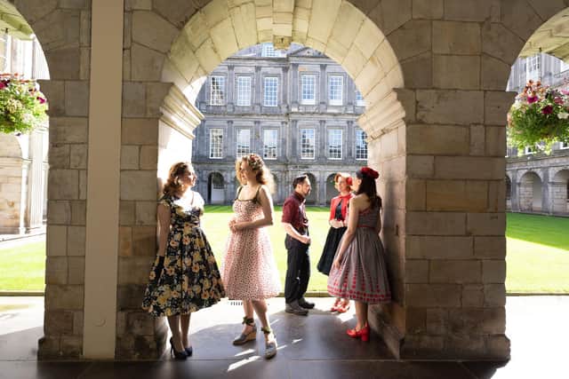 Holyrood Club dressed in 1950s clothes pose around Holyrood Palace,Edinburgh Photograph: David Cheskin