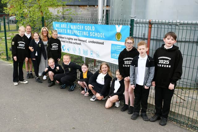 Carronshore Primary School's Children's Rights Champions and Angela Gallagher with their gold banner. Pic: Michael Gillen