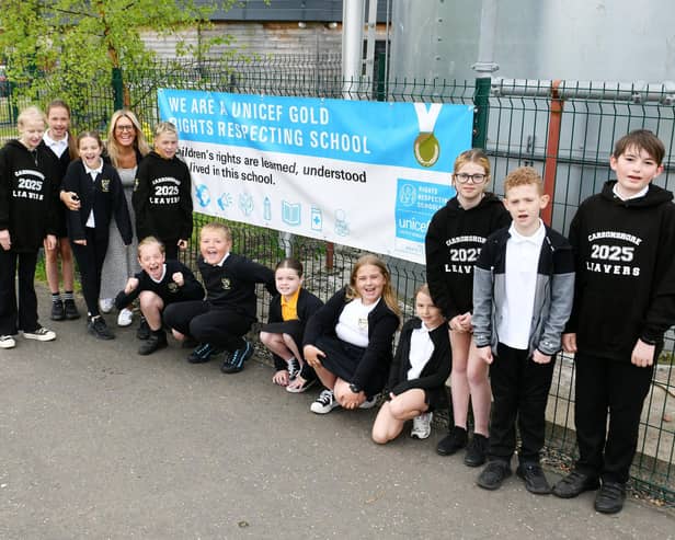 Carronshore Primary School's Children's Rights Champions and Angela Gallagher with their gold banner. Pic: Michael Gillen