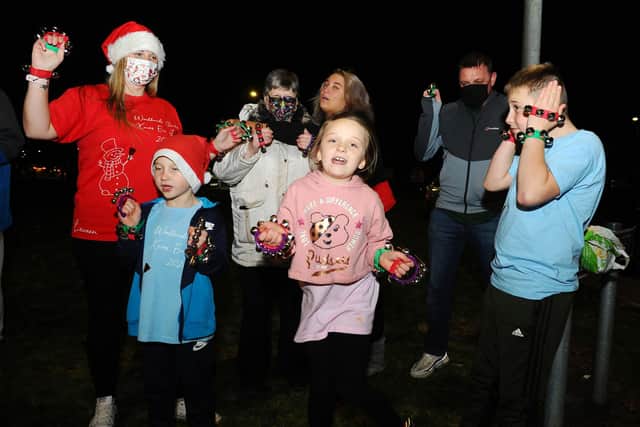 Lauren Sinclair (left), founder of the Worldwide Santa's Christmas Eve Jingle Facebook group, with family, friends and neighbours jingling their bells. Picture: Michael Gillen.