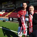 Stenhousemuir captain Gregor Buchanan and manager Gary Naysmith hold the League Two trophy after the 1-1 draw with Bonnyrigg Rose at Ochilview last month (Photo: Michael Gillen)