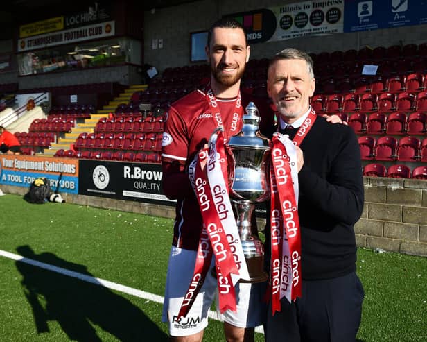 Stenhousemuir captain Gregor Buchanan and manager Gary Naysmith hold the League Two trophy after the 1-1 draw with Bonnyrigg Rose at Ochilview last month (Photo: Michael Gillen)