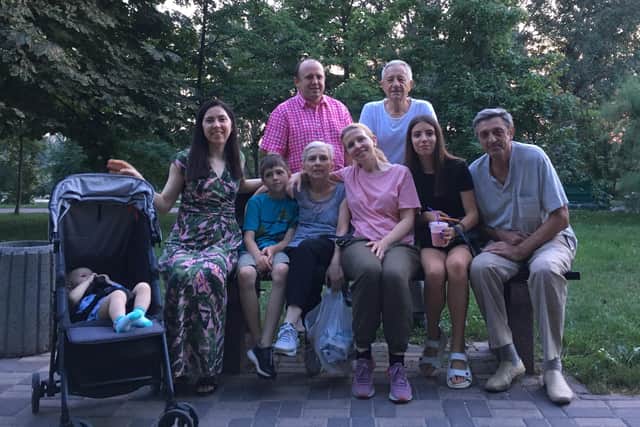 The family together back home in Ukraine during happier times, with Anastasia pictured, in pink t-shirt in front row.