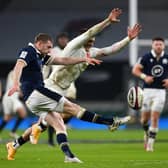 Finn Russell  kicks upfield as Henry Slade of England attempts to charge down during Scotland 11-6 win at Twickenham (Photo by Mike Hewitt/Getty Images)