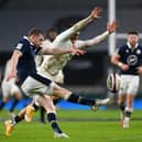 Finn Russell  kicks upfield as Henry Slade of England attempts to charge down during Scotland 11-6 win at Twickenham (Photo by Mike Hewitt/Getty Images)