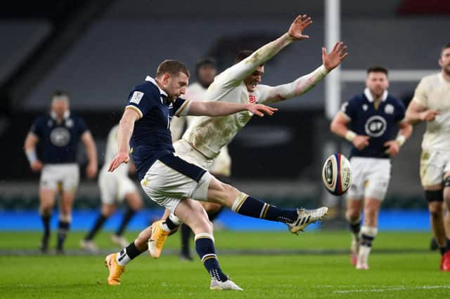 Finn Russell  kicks upfield as Henry Slade of England attempts to charge down during Scotland 11-6 win at Twickenham (Photo by Mike Hewitt/Getty Images)