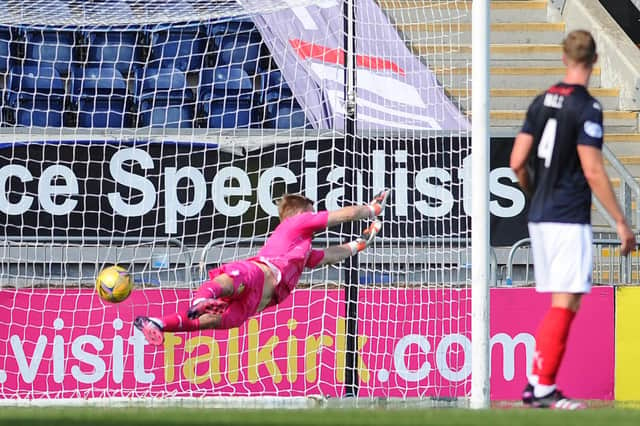 Simon Murray's free-kick eludes the diving Robbie Mutch to send Falkirk to their first league defeat of the season (pic: Michael Gillen)
