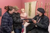 Guests could browse a selection of works from various artists inside the Travelling Gallery bus. (Michael Gillen).