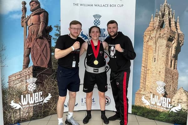 Stephanie Kernachan with her William Wallace Box Cup gold medal pictured alongside Falkirk Phoenix Boxing Club coaches Alan Hill, left and Jamie Hill, right (Photo: Submitted)