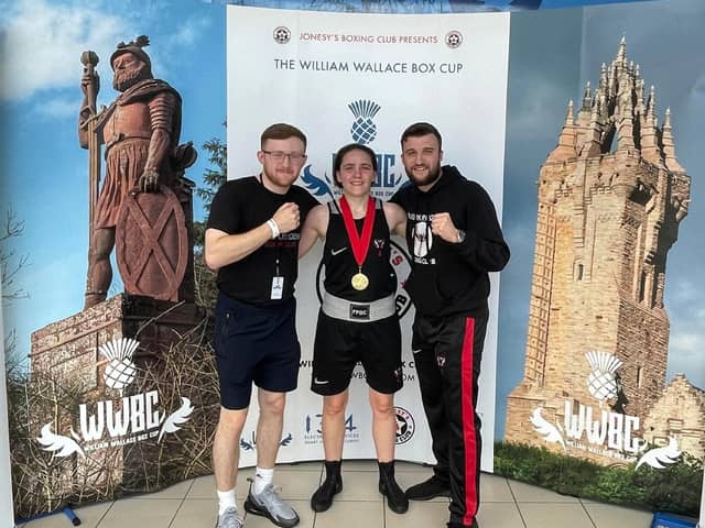 Stephanie Kernachan with her William Wallace Box Cup gold medal pictured alongside Falkirk Phoenix Boxing Club coaches Alan Hill, left and Jamie Hill, right (Photo: Submitted)
