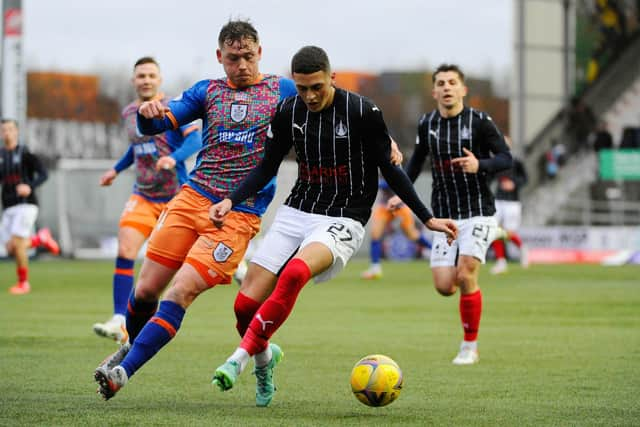 Jaze Kabia battles to keep a hold of the ball in midfield